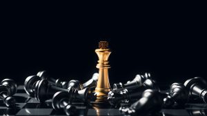 Market Alert Ltd. Helps Companies Stay Ahead Of Their Competition - a golden king stands on a chess board surrounded by fallen pieces.